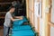 Male workers prepare t-shirts placed on the board