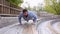 Male working out his arm muscles outdoor. Man doing push up exercise in summer park