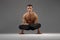 Male yoga keeps balanc on hands in classical pose