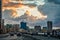 Malecon promenade street with walking people and road with traffic in the evening time with sunset clouds, Havana, Cuba