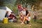 Males and females at music summer festival playing guitar in nat