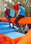 Males fighting on log at outdoor amusement playground