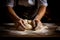 Males hands kneading dough on wooden table. Close up