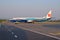 Malindo Air plane parked next to airport runway preparing for next flight