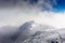 Maliovica peak in the mists of the clouds at the Rila mountain in Bulgaria