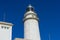 Mallorca, lighthouse next to the Mediterranean Sea, blue sky wit