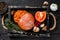 Mallorcan Sobrassada cured pork meat sausage in a wooden tray. Black wooden background. Top view