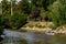 MalmÃ¶, Sweden - August 10, 2018: Two people are rowing a canoe through the canals of the city, a common sight and activity in the