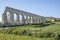 Malta, The Aqueducts on the side of the Victoria in Gozo, maltese landscape with the fresh vegetable field and blue sky