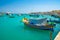 Malta. Beautiful view on the traditional eyed colorful boats Luzzu in the Harbor of Mediterranean fishing village Marsaxlokk, Malt