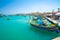 Malta. Beautiful view on the traditional eyed colorful boats Luzzu in the Harbor of Mediterranean fishing village Marsaxlokk, Malt