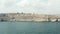 Malta Capital City Valletta from Ocean view, Aerial Dolly forward towards Beige City in Blue Water in foreground