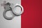 Malta flag and police handcuffs. The concept of crime and offenses in the country