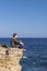 Malta Gozo, Young man watching the ocean on a bright day at Gharb, Malta Gozo