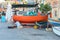 Malta, Marsaxlokk, August 2019. A sailor repairs a boat on the shore.