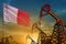 Malta oil industry concept. Industrial illustration - Malta flag and oil wells against the blue and yellow sunset sky background