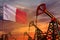 Malta oil industry concept. Industrial illustration - Malta flag and oil wells with the red and blue sunset or sunrise sky