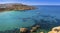 Malta - Snorkeling man and sail boat at Ghajn Tuffieha bay