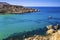 Malta - Snorkeling man and sail boat at Ghajn Tuffieha bay