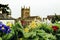 Malvern Priory out of focus with flowers in the foreground