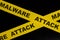 Malware attack cybercrime alert, caution and warning concept. Yellow barricade tape with word