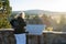 Mammoth Lakes, California - July 11, 2019: Woman tourist reads the interpretive sign at the Hot Creek Geological Site about the