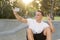 Man 30s sitting on skate board after sport boarding training session taking selfie photograph portrait or picture on mobile phone