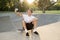 Man 30s sitting on skate board after sport boarding training session taking selfie photograph portrait or picture on mobile phone