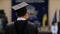 Man in academic dress excited about receiving diploma at graduation ceremony