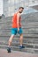Man in active wear and sneakers on steps. Sportsman workout on stairs. Fit and confident. Future and success. Ready to