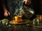 A man adds boiling water to a mug to make healthy tea on the kitchen table. Traditional medicine concept or preparation of