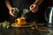 A man adds motherwort to a mug of boiling water to make a soothing tea. Traditional medicine concept or making medicinal tea.