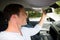 Man adjusting rearview mirror in car