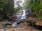 A man admires a waterfall in northern Thailand