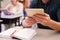 Man at adult education class holding tablet, hands detail