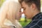 A man affectionately call looks at woman, guy and girl are worth close, touching tips noses. The concept of first teenage love and