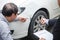 Man agent Filling Insurance Form Near Damaged and examining Car, Traffic Accident and insurance concept