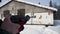 A man aiming a pellet gun towards a target, practicing his aim in the winter. Clip. The shooter in camouflage targets a