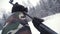A man aiming a pellet gun towards a target, practicing his aim in the winter. Clip. The shooter in camouflage targets a