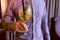 Man with alcohol cocktail with sparkling wine, ice and liquor in wineglass, puts it on the table. Hands close-up.