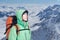 Man alpinist looks up against a winter mountain landscape.