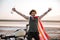 Man in american flag cape with hands up in air