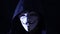 man in an anonymous mask on a black background