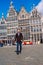 A man on Antwerp square with the city hall and Brabo monument in the Old city