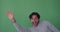 Man appearing waving hand and disappearing on green screen