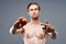 Man with apple and sport healthy food pumped up cake bodybuilder