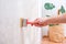 A man applies wallpaper glue with brush for wallpapering. Repair of a room, apartment, house.