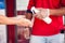 Man applying antibacterial spray on hands of customer at the supermarket entrance. Virus protection concept