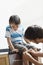 Man Applying Bandage On His Son\'s Knee