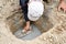 Man applying cement in soil hole